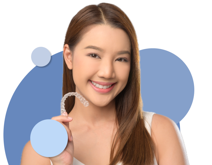 Close Up Portrait Of Lady With Long Dark Hair Smiling Holding Clear Retainer